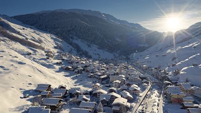 The village of Vals in the winter, where the sun is shining brightly.