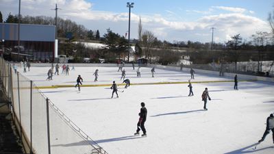 People are skating on the ice rink in Bülach at Hirslen sports center.