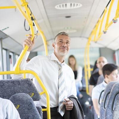 A passenger holding on to a yellow handrail