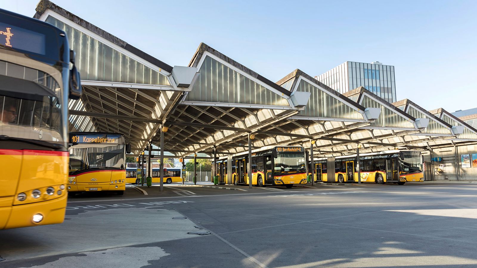 Postbuses waiting at the “Bern, Hauptbahnhof” stop, which is called the Bern PostBus station.